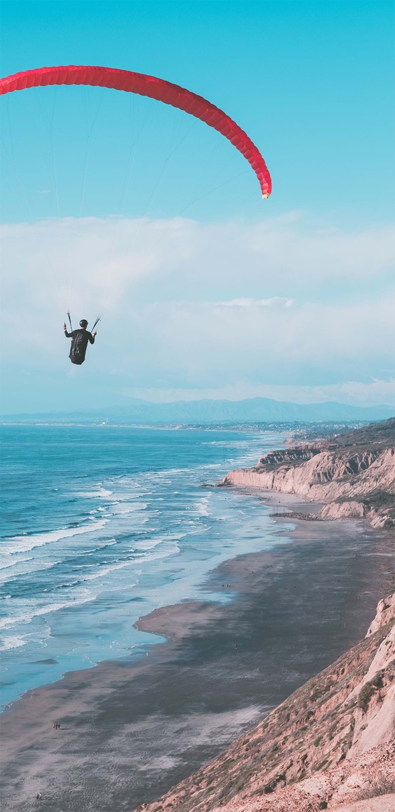 Paraglider over beach