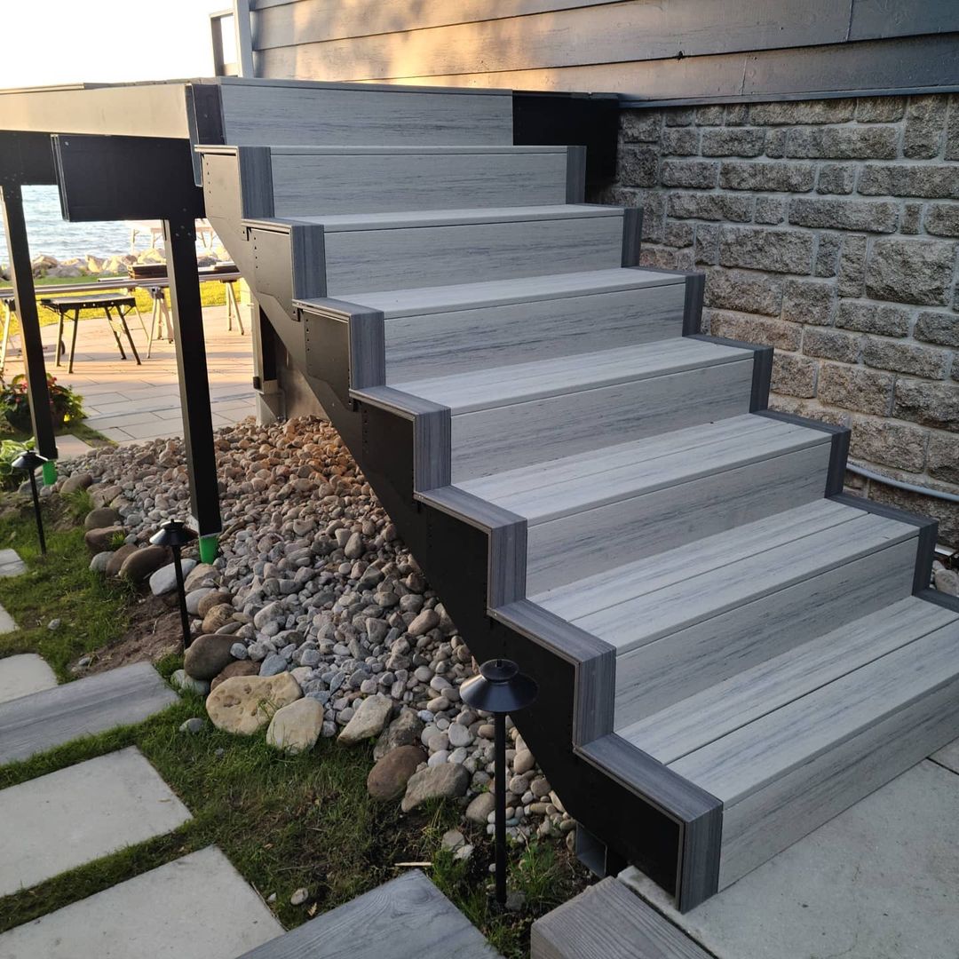 Modern deck stairs framed with durable steel, featuring deck joist spacing and high-quality composite decking.