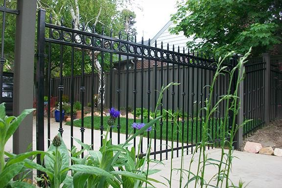 Metal gate enclosing a backyard