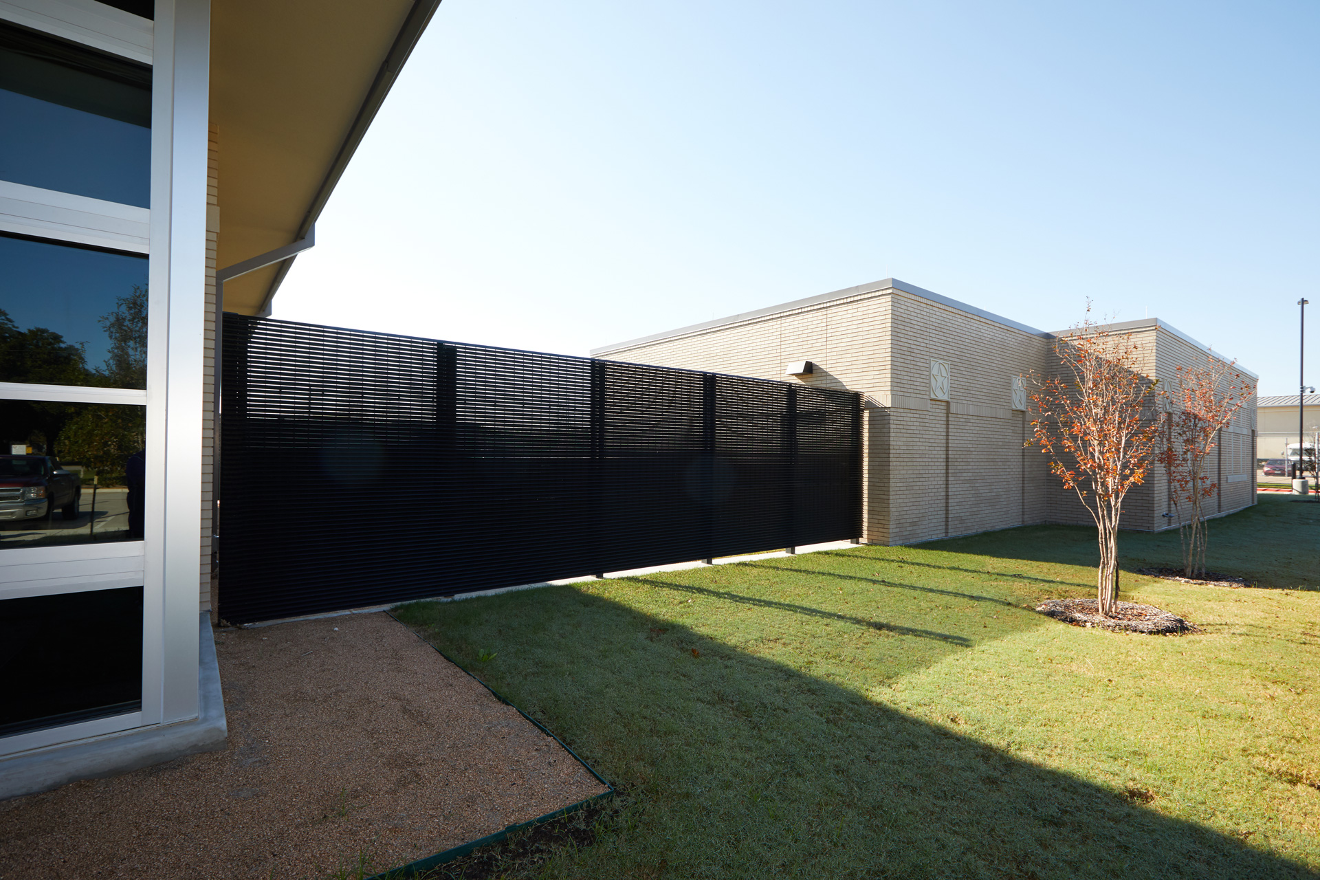 Black security fencing obscures the view of inner school grounds. 