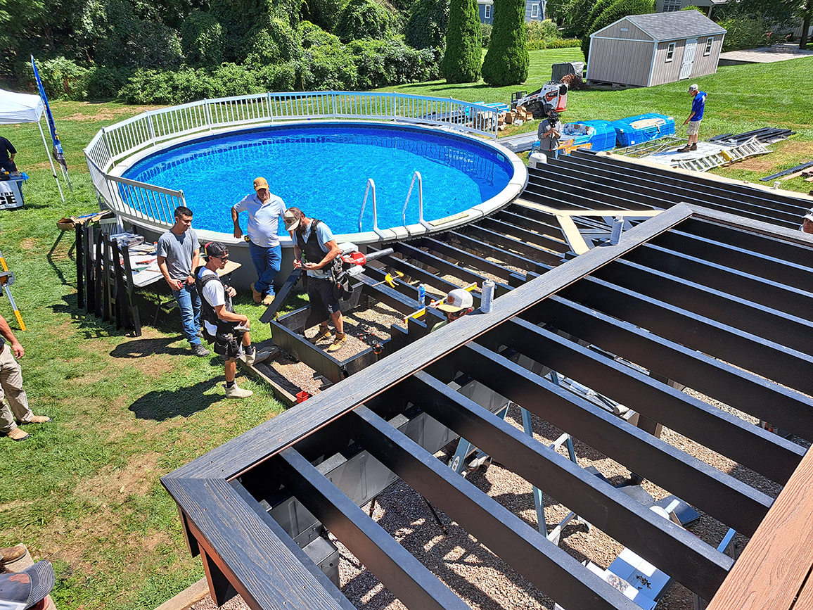 Ravin Builders installing steel deck framing near a round pool.