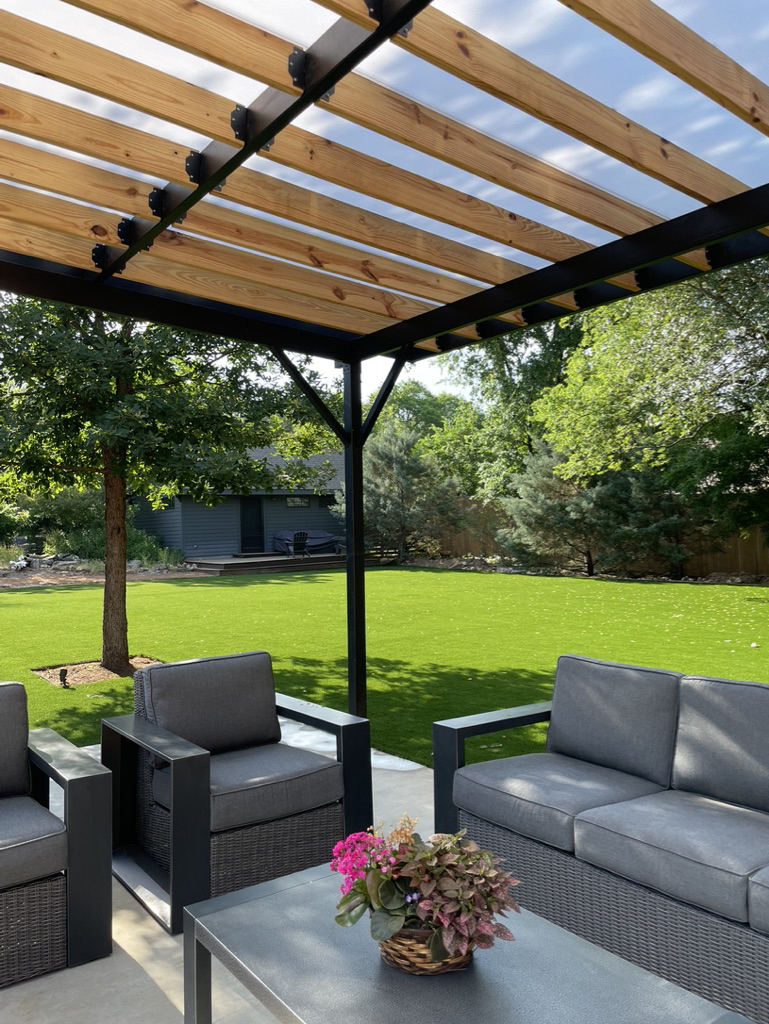 Comfortable outdoor seating area under a traditional wood pergola.