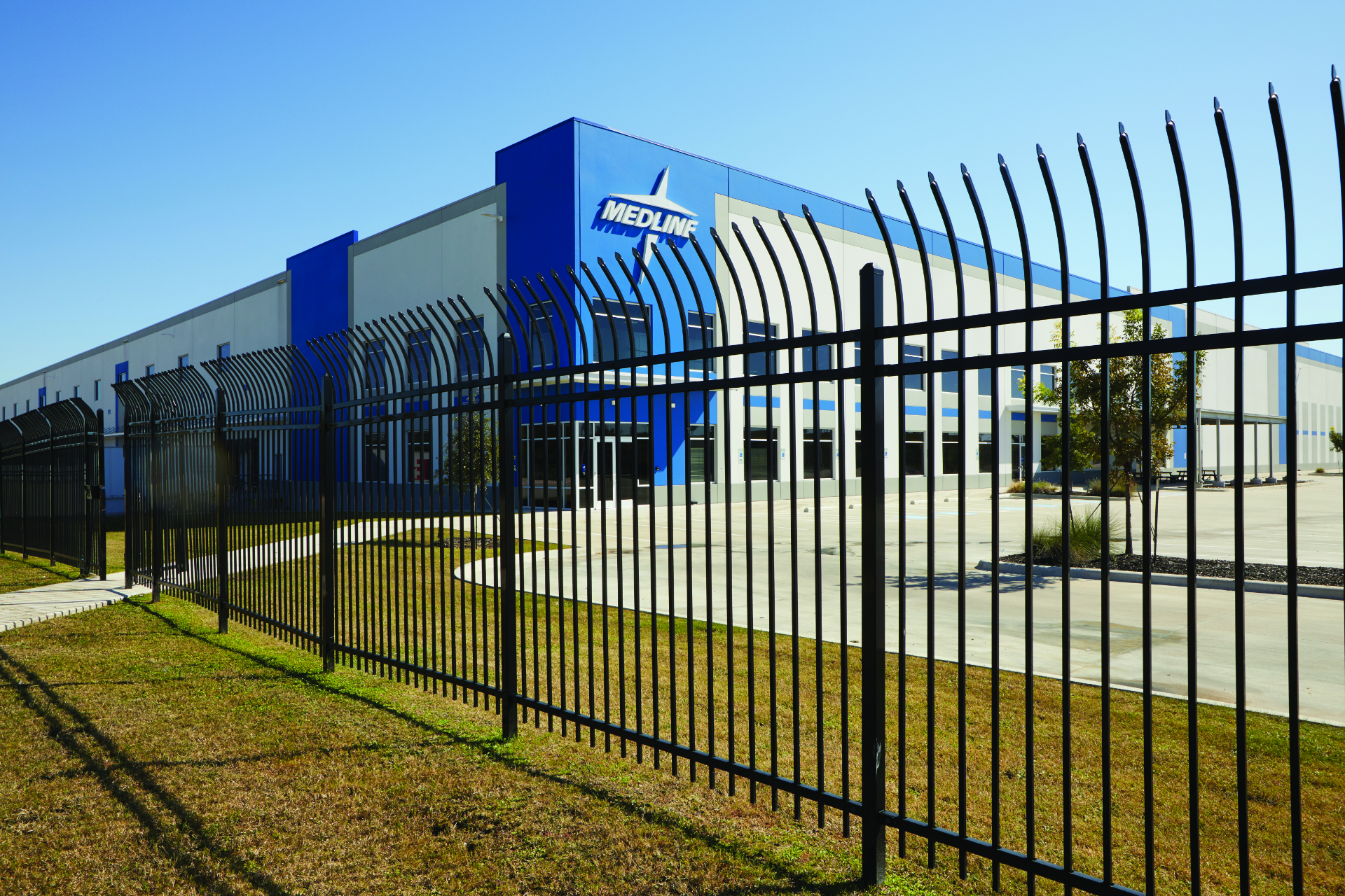Modern steel fence surrounding a commercial building with Medline logo.