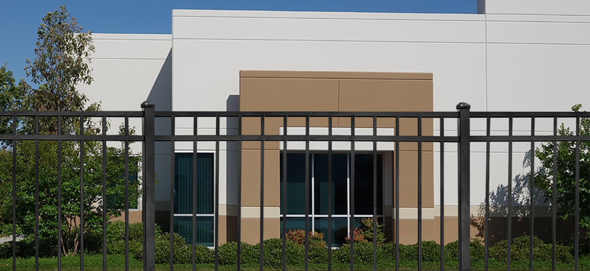 black aluminum commercial fencing in front of office building