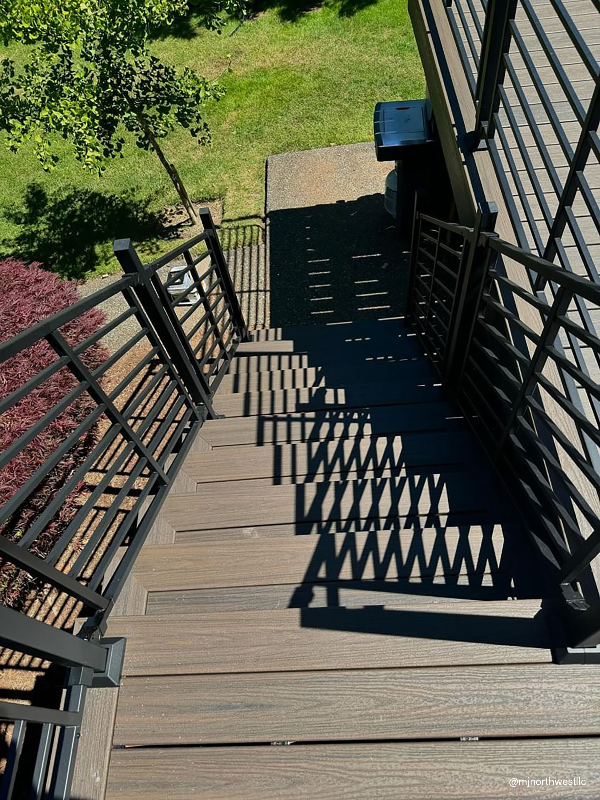 Multi-level wooden deck featuring a railing and stairs for access between levels.