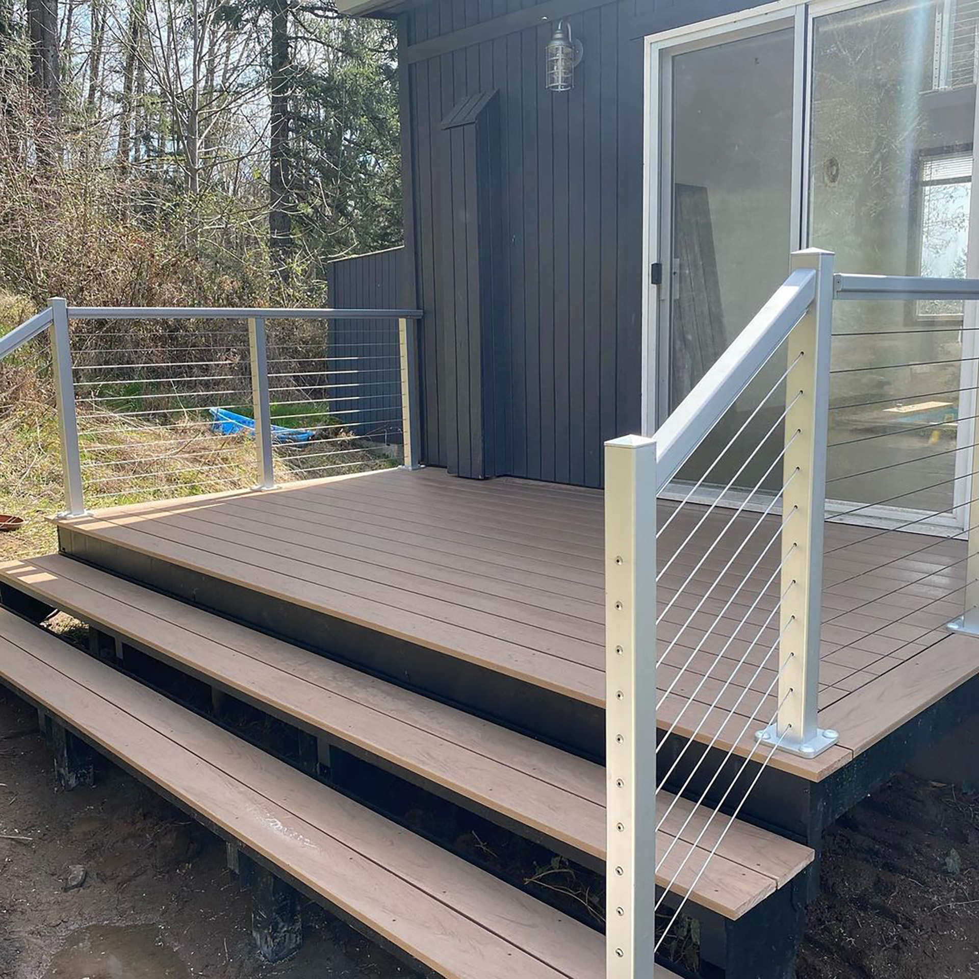 Completed residential deck with steel framing and modern railings.