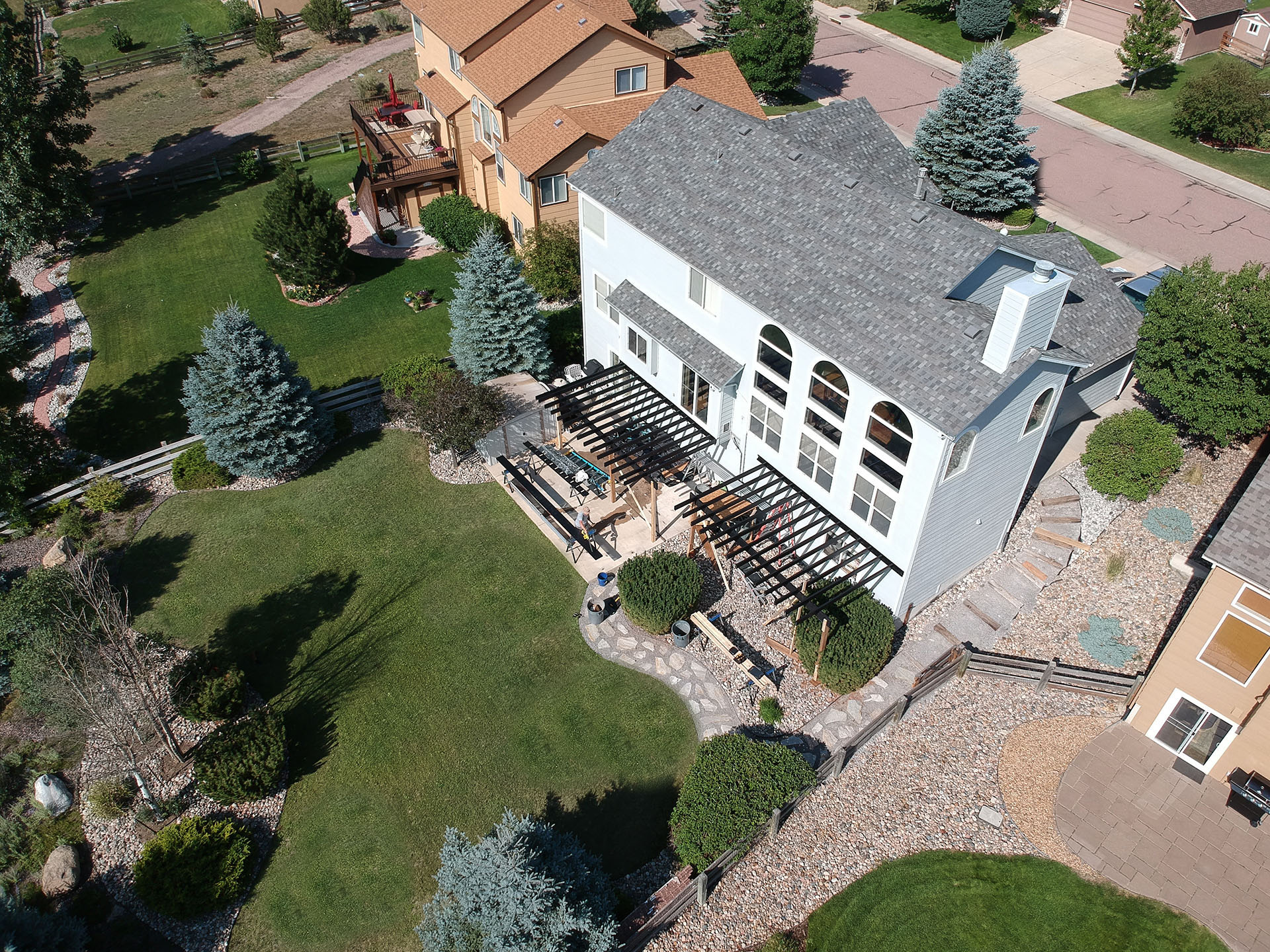 Aerial view of residential property with steel-framed deck under construction.