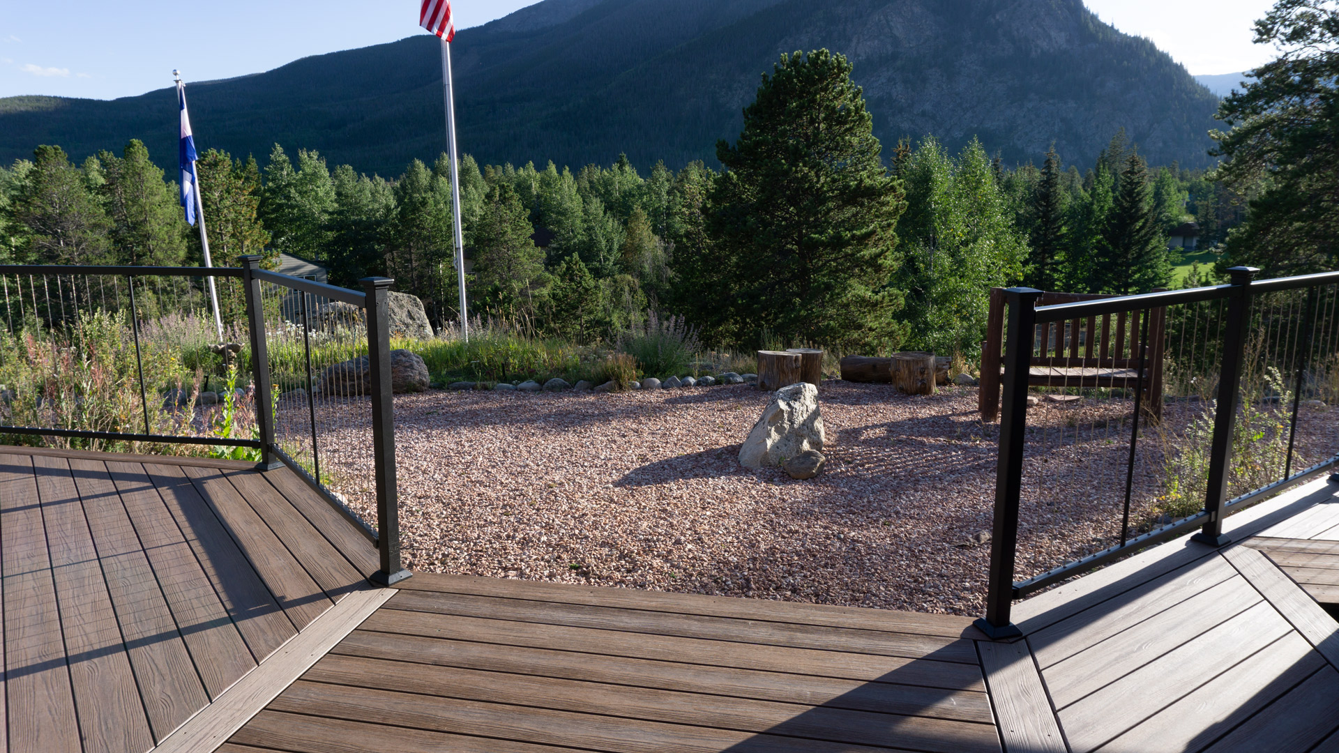 cable railing on composite decking with mountain backdrop 