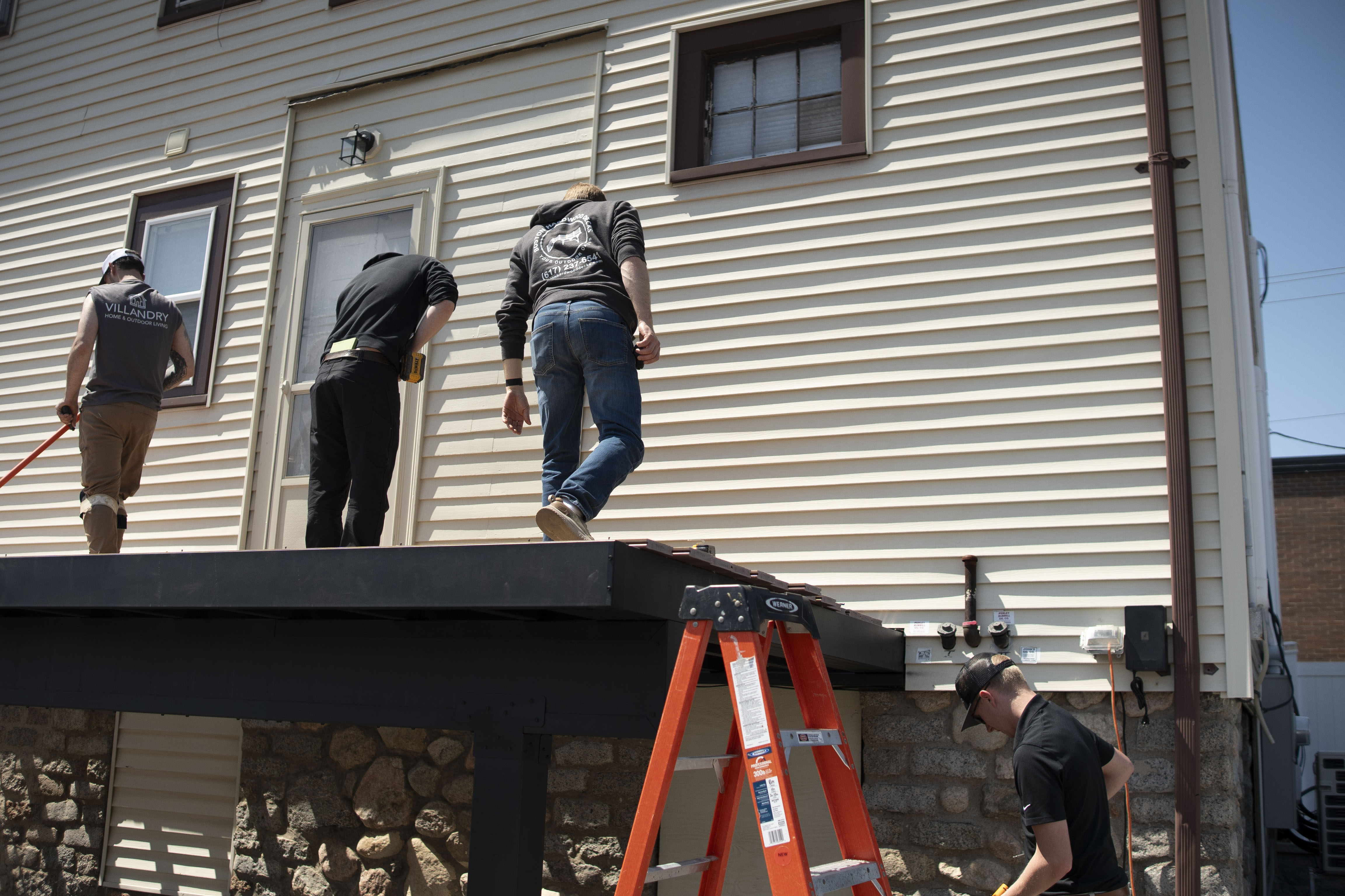 Builders install Evolution steel framing on a residential home, showcasing modern deck framing methods and product durability.