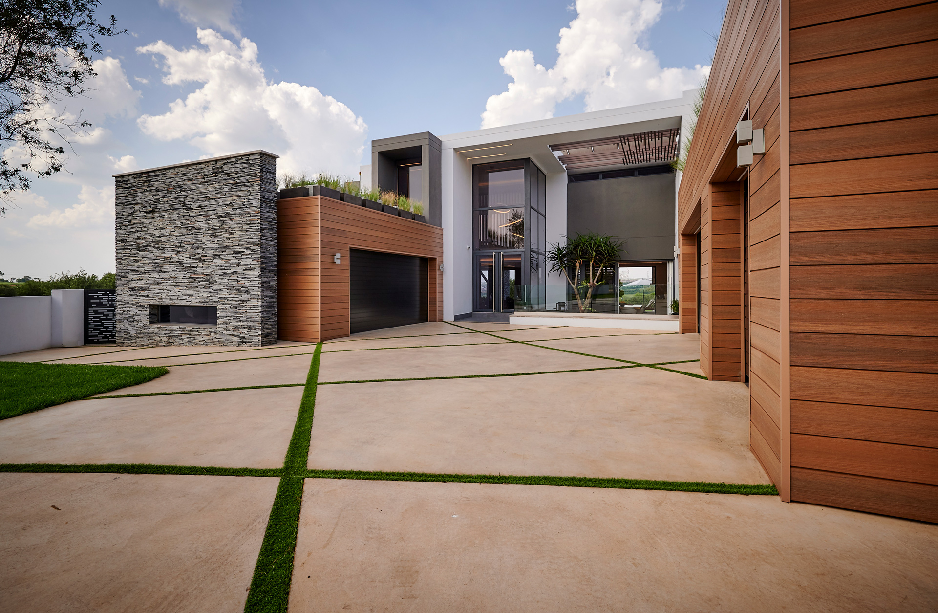 Driveway in front of home with modern wall cladding