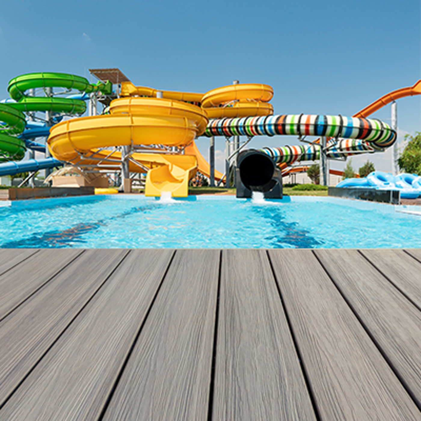 Composite deck boards shown at the bottom of water slides at a theme park. 
