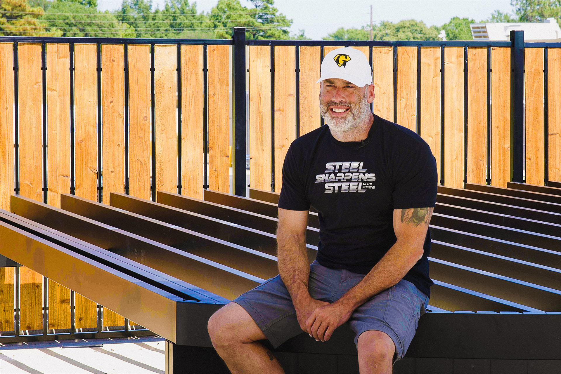 Scott Kelly, owner of Precision Construction, sitting on a steel deck frame.