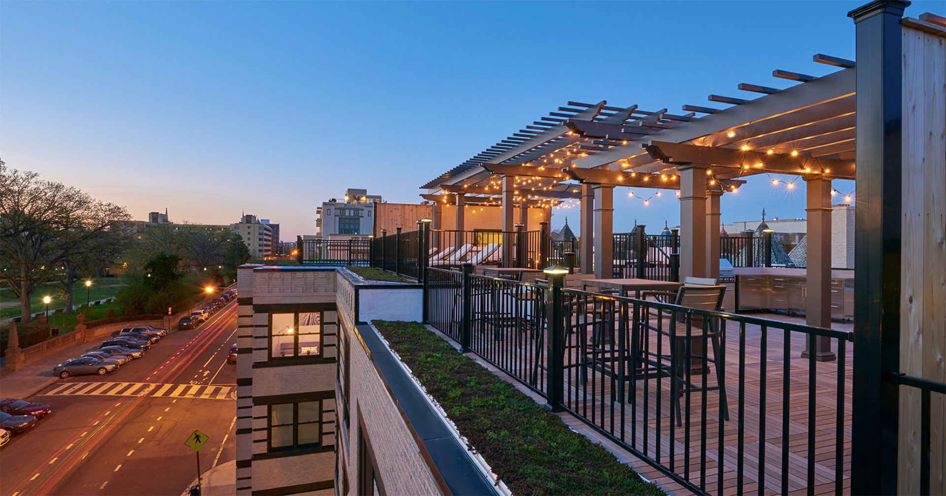 Rooftop deck showing off stunning skyline views with string lights creating a cozy outdoor space.