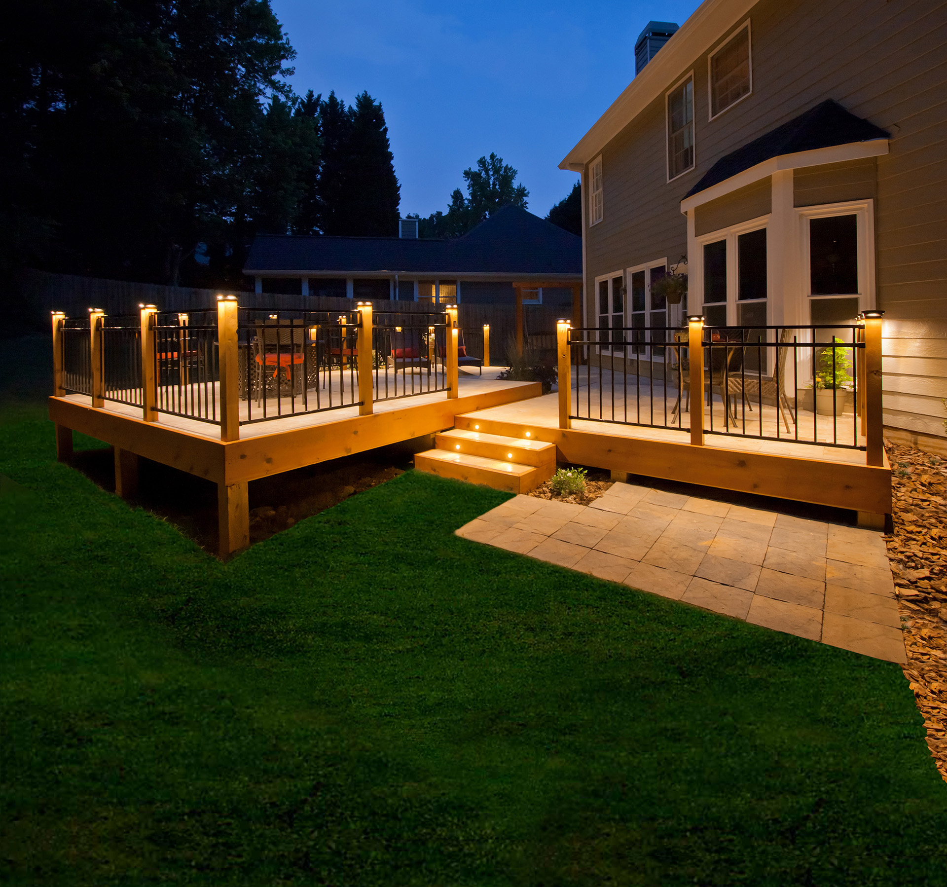 Deck post lights on exterior balcony railings creating light for the outdoor deck space.