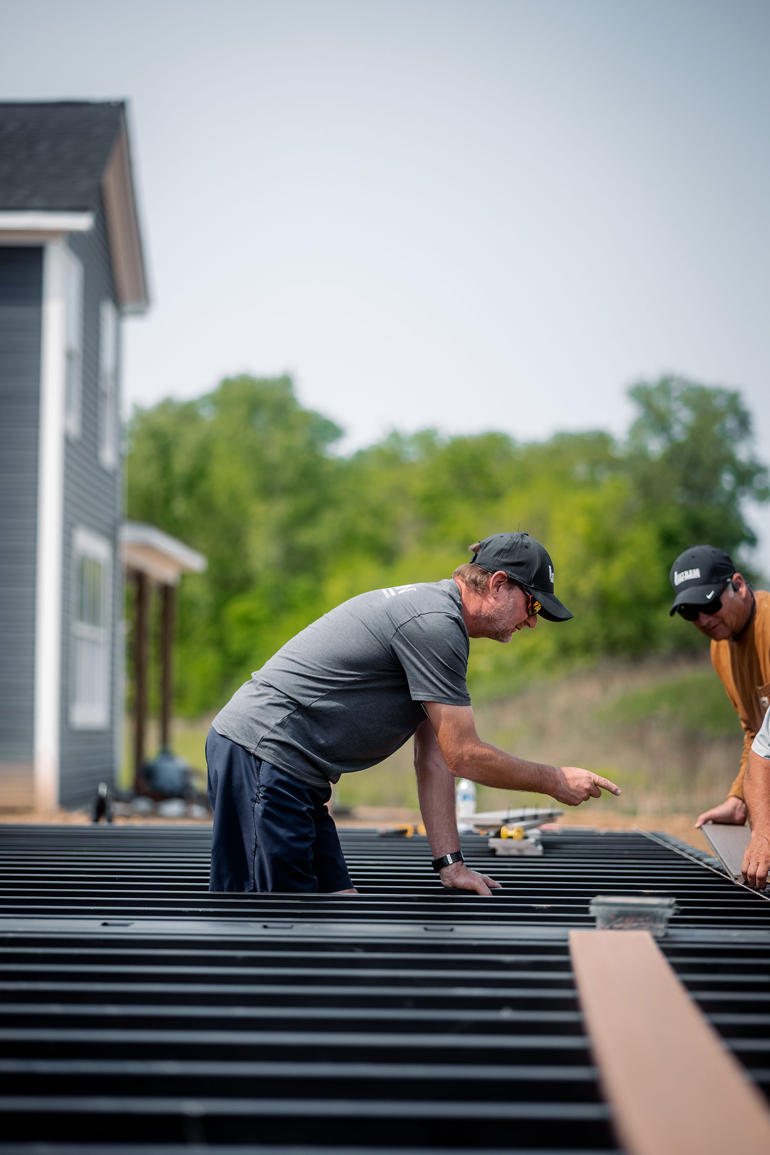 Man working on building a steel deck frame.