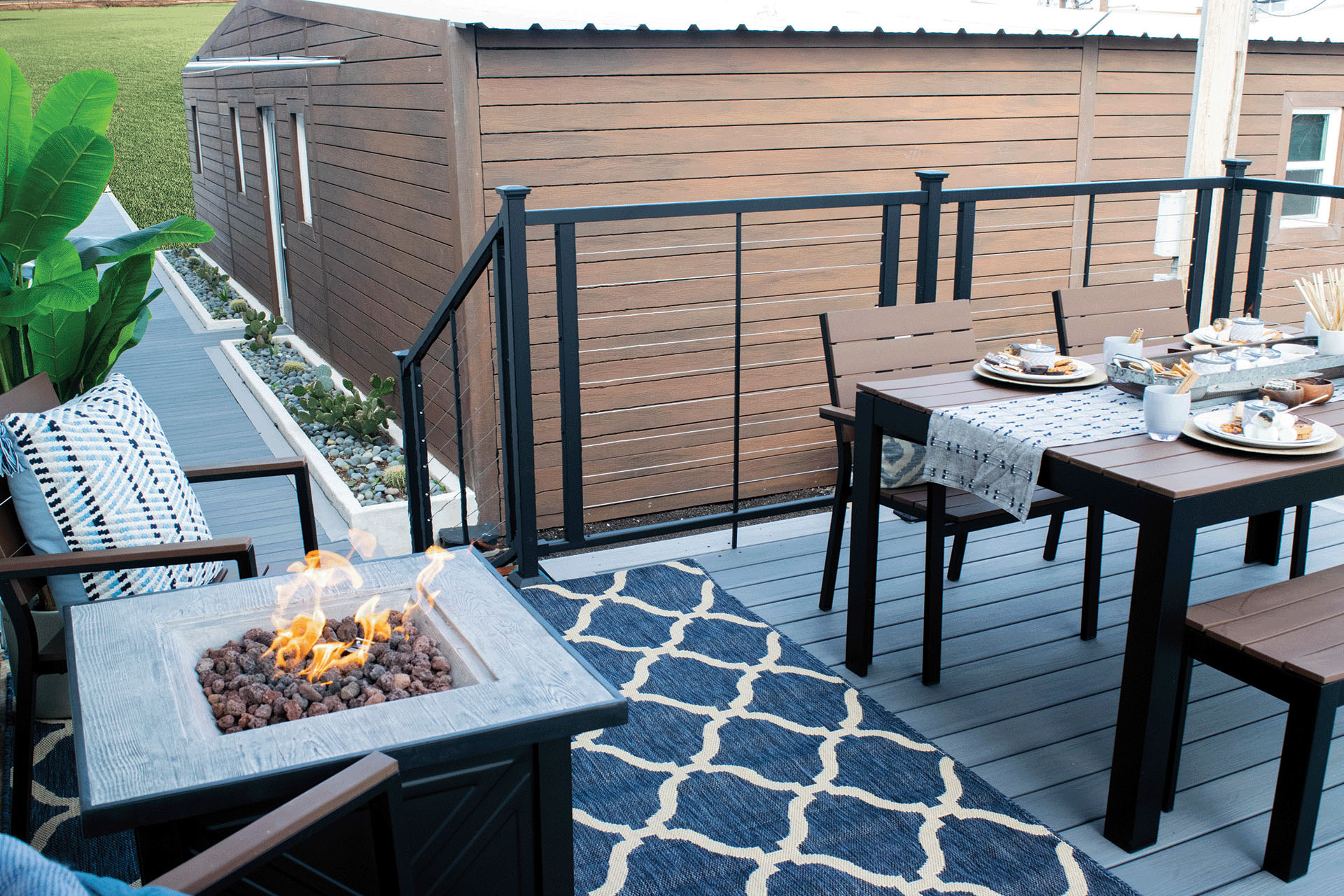 Outdoor dining area with steel railings on a raised deck
