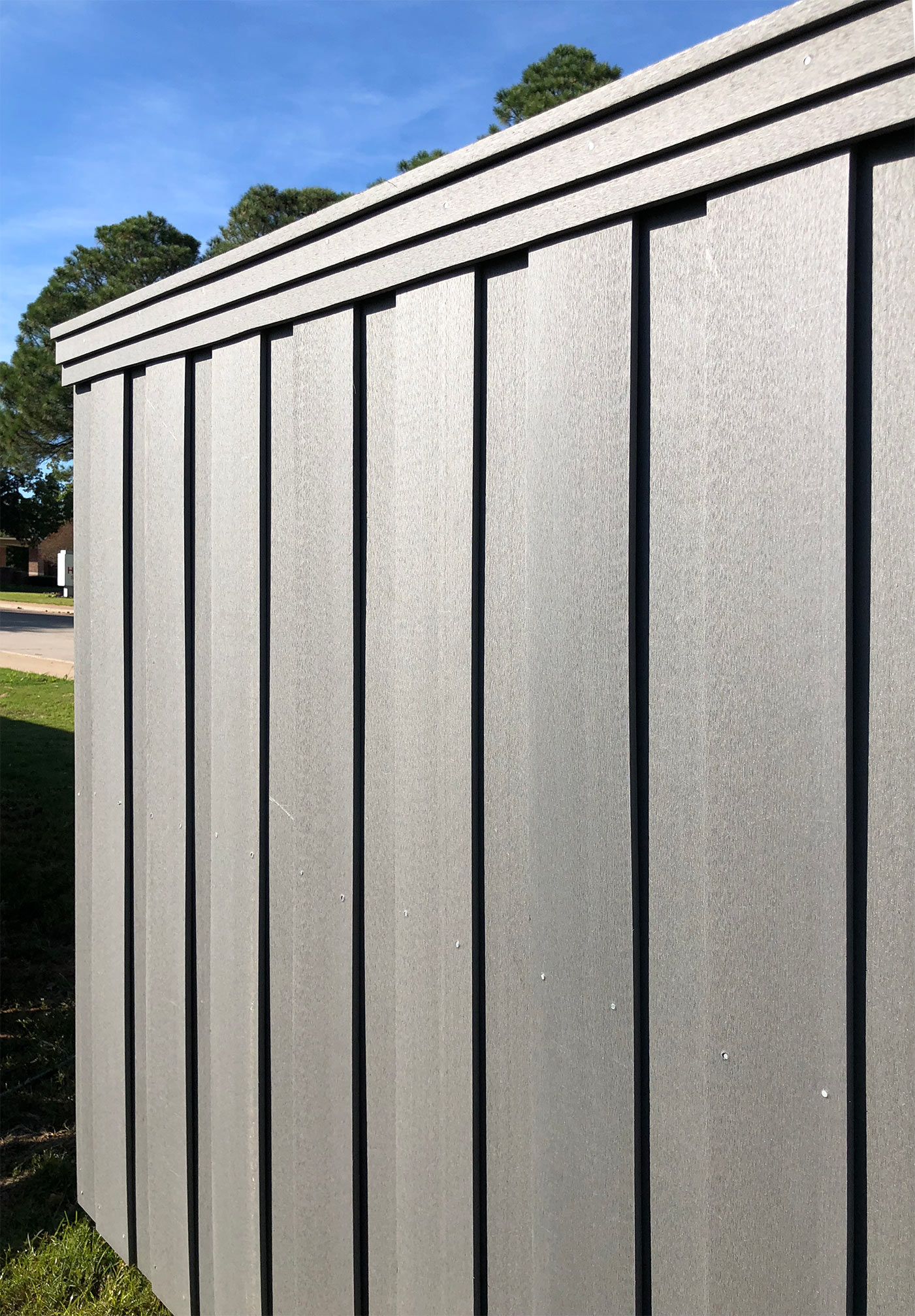 Close up view of dark composite fencing made from recycled materials