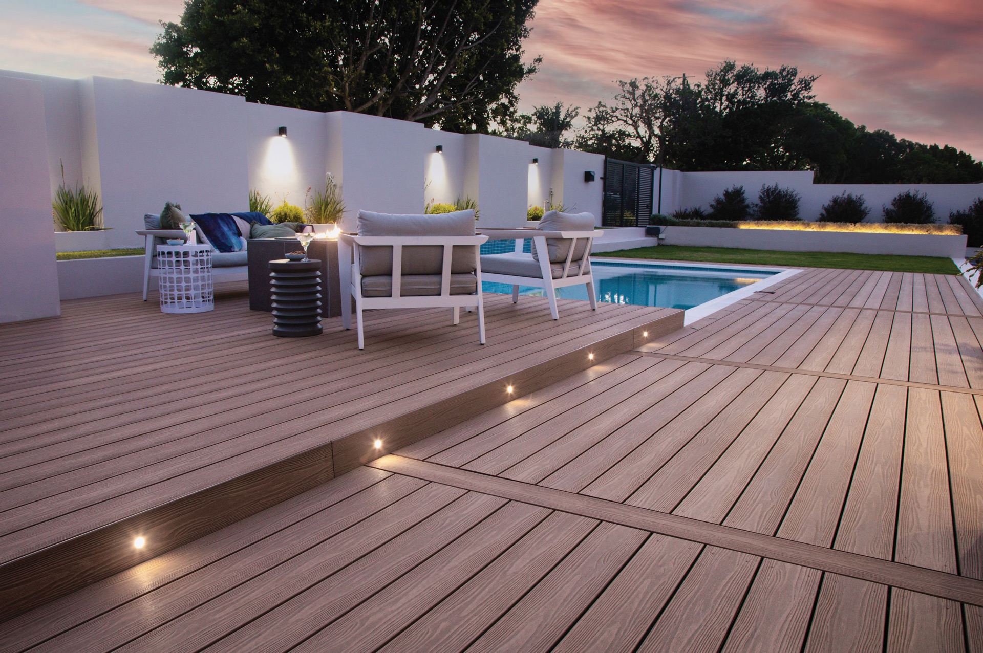 Ground level composite deck surrounding a pool