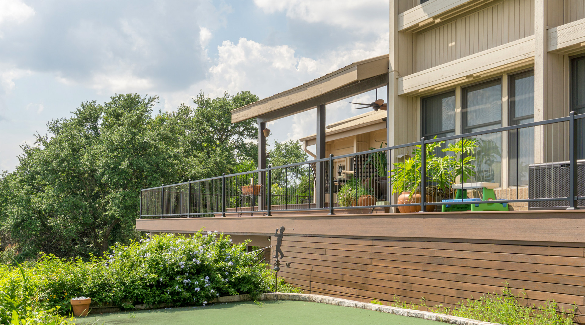 Steel cable railing wraps around a large deck