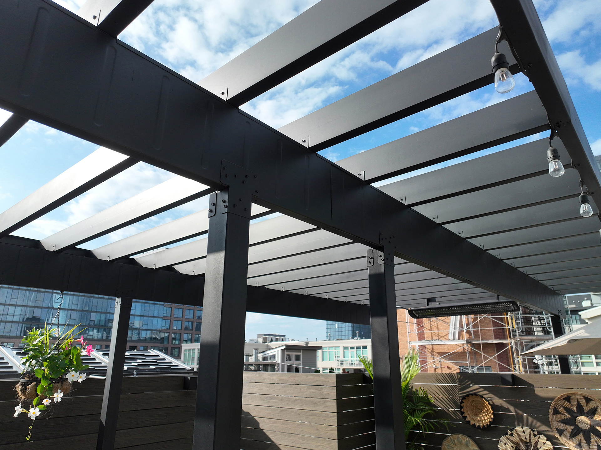 Close-up of a steel pergola showcasing its structure and powder-coated finish.